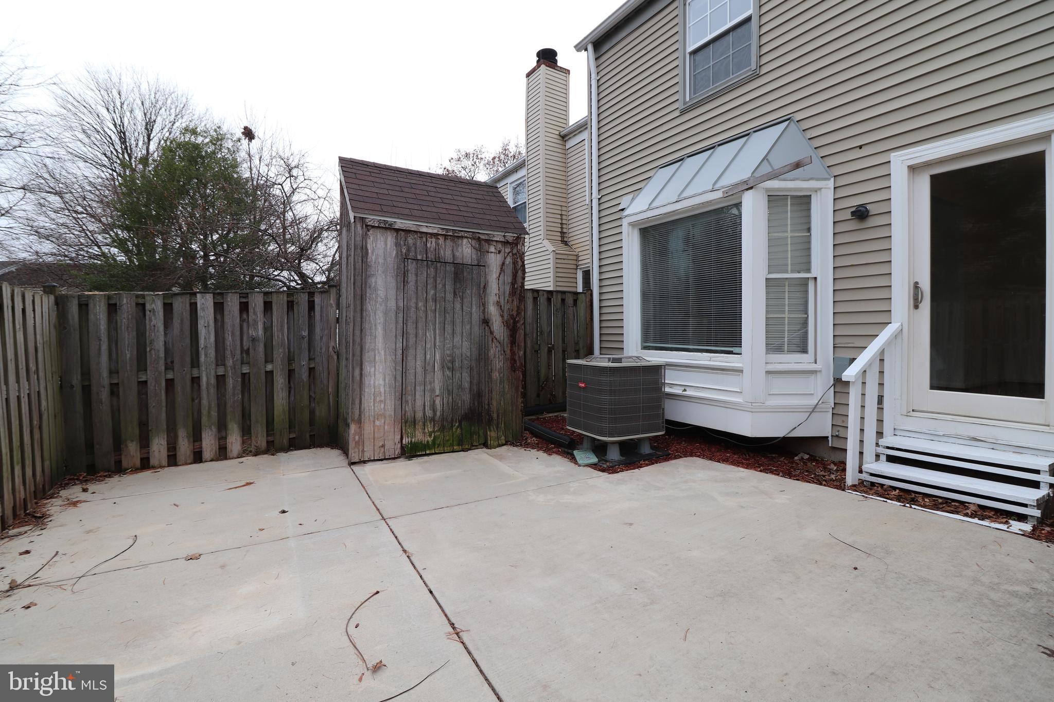 138 Sharpstead Lane Gaithersburg, MD 20878 - Photo 34 of 36 a backyard of a house with barbeque oven and wooden fence