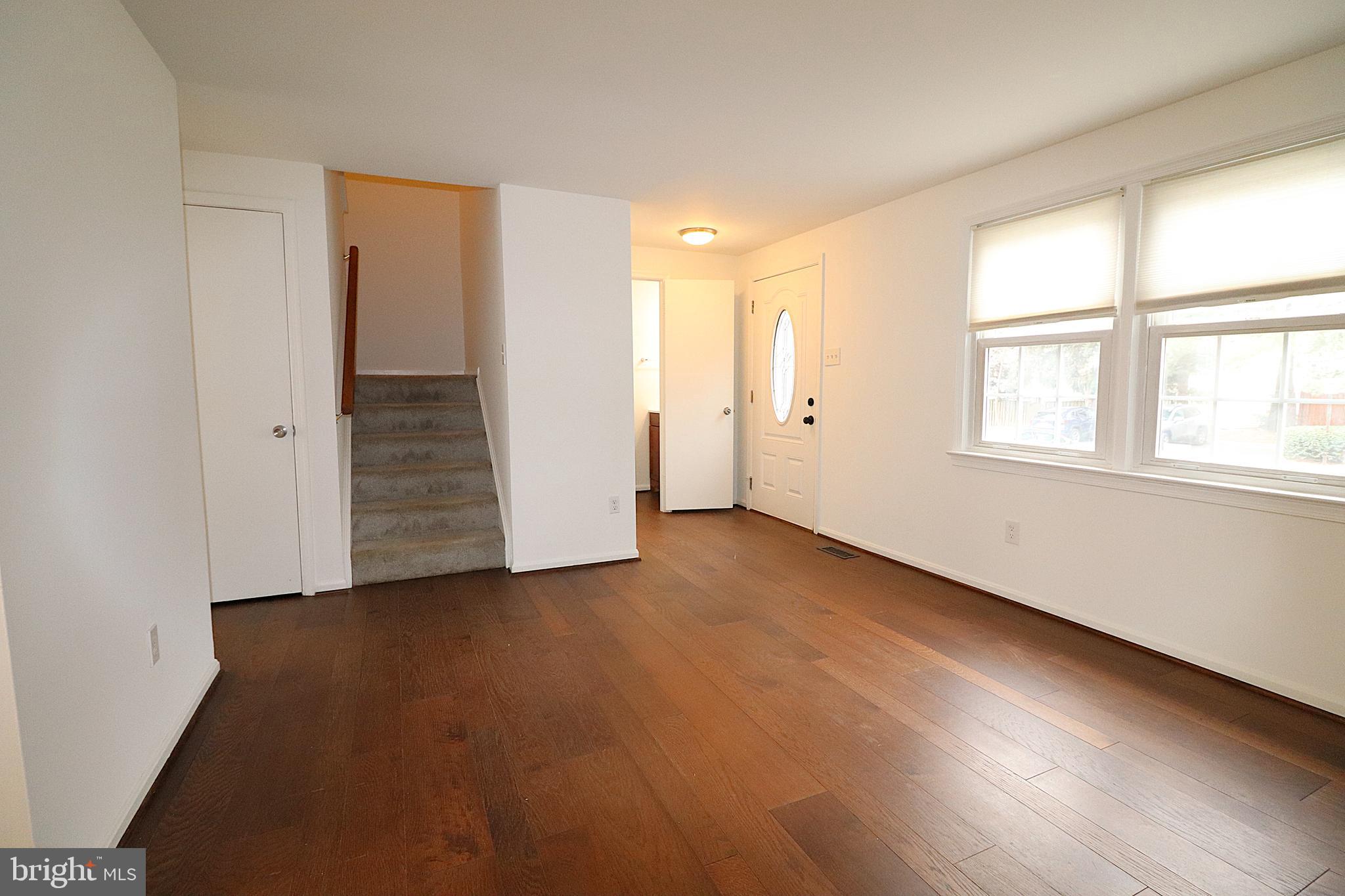 138 Sharpstead Lane Gaithersburg, MD 20878 - Photo 4 of 36 an empty room with wooden floor and windows
