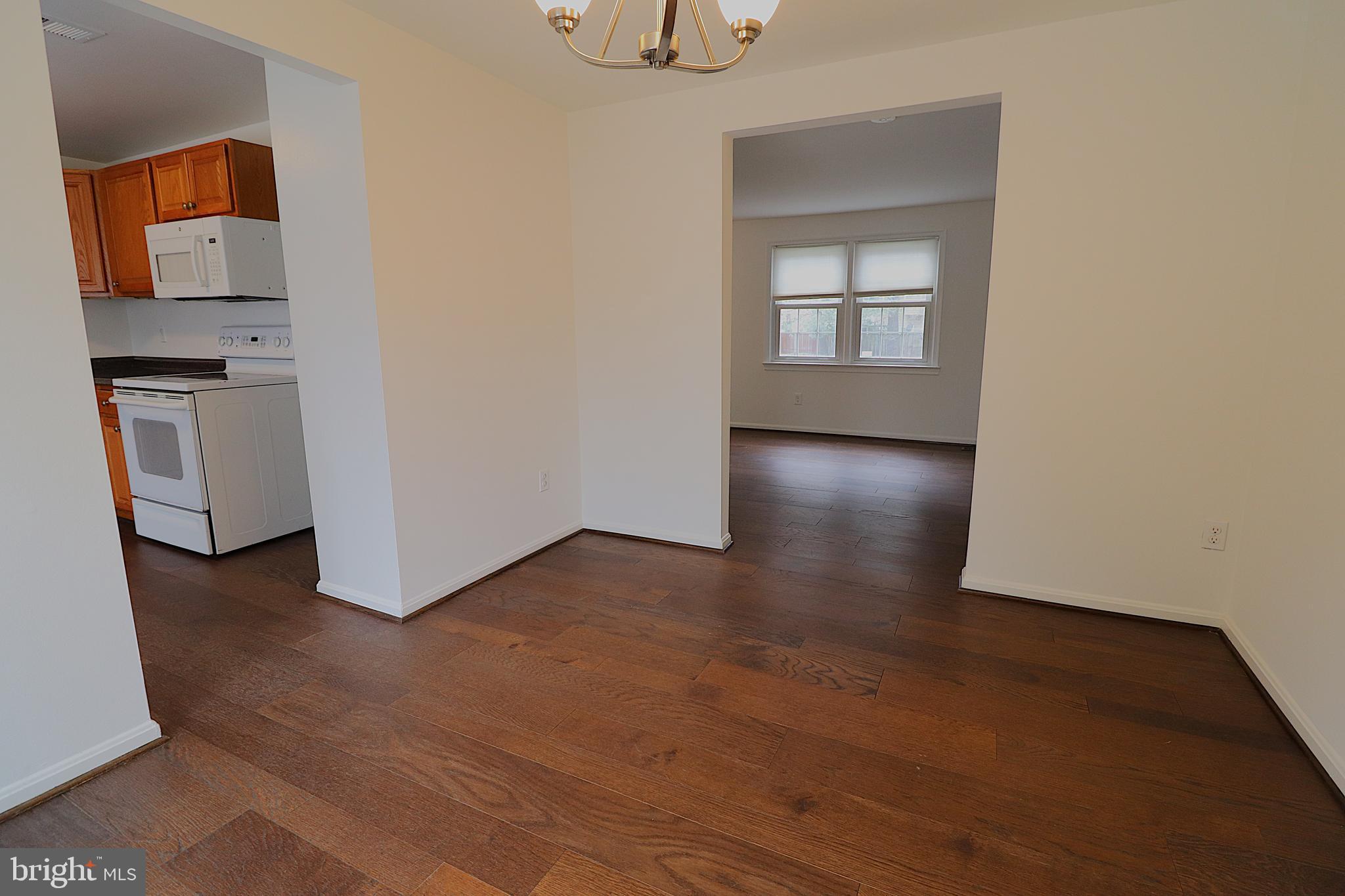138 Sharpstead Lane Gaithersburg, MD 20878 - Photo 6 of 36 a view of an empty room with a window and wooden floor