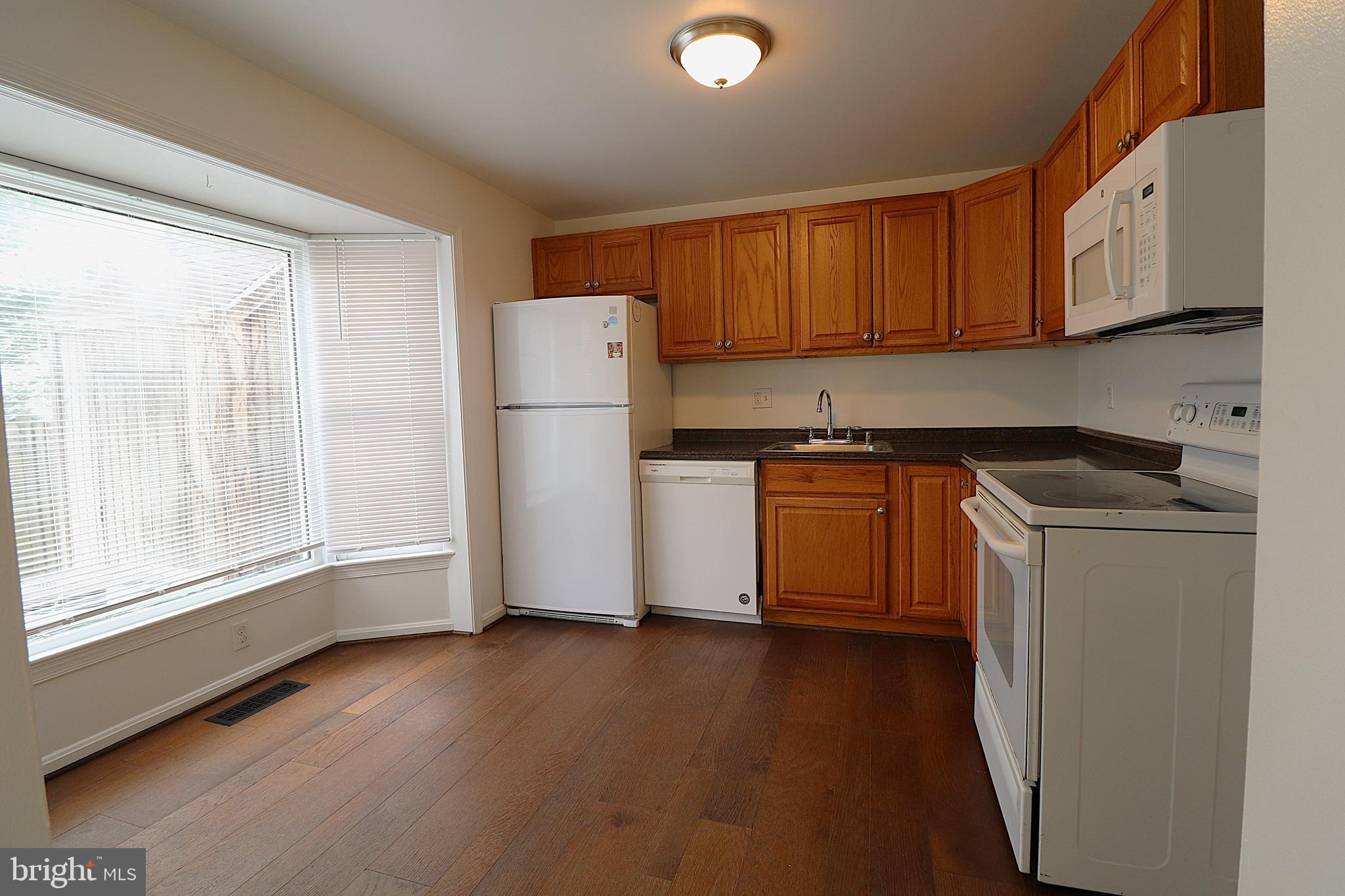 138 Sharpstead Lane Gaithersburg, MD 20878 - Photo 8 of 36 a kitchen with a refrigerator sink and cabinets