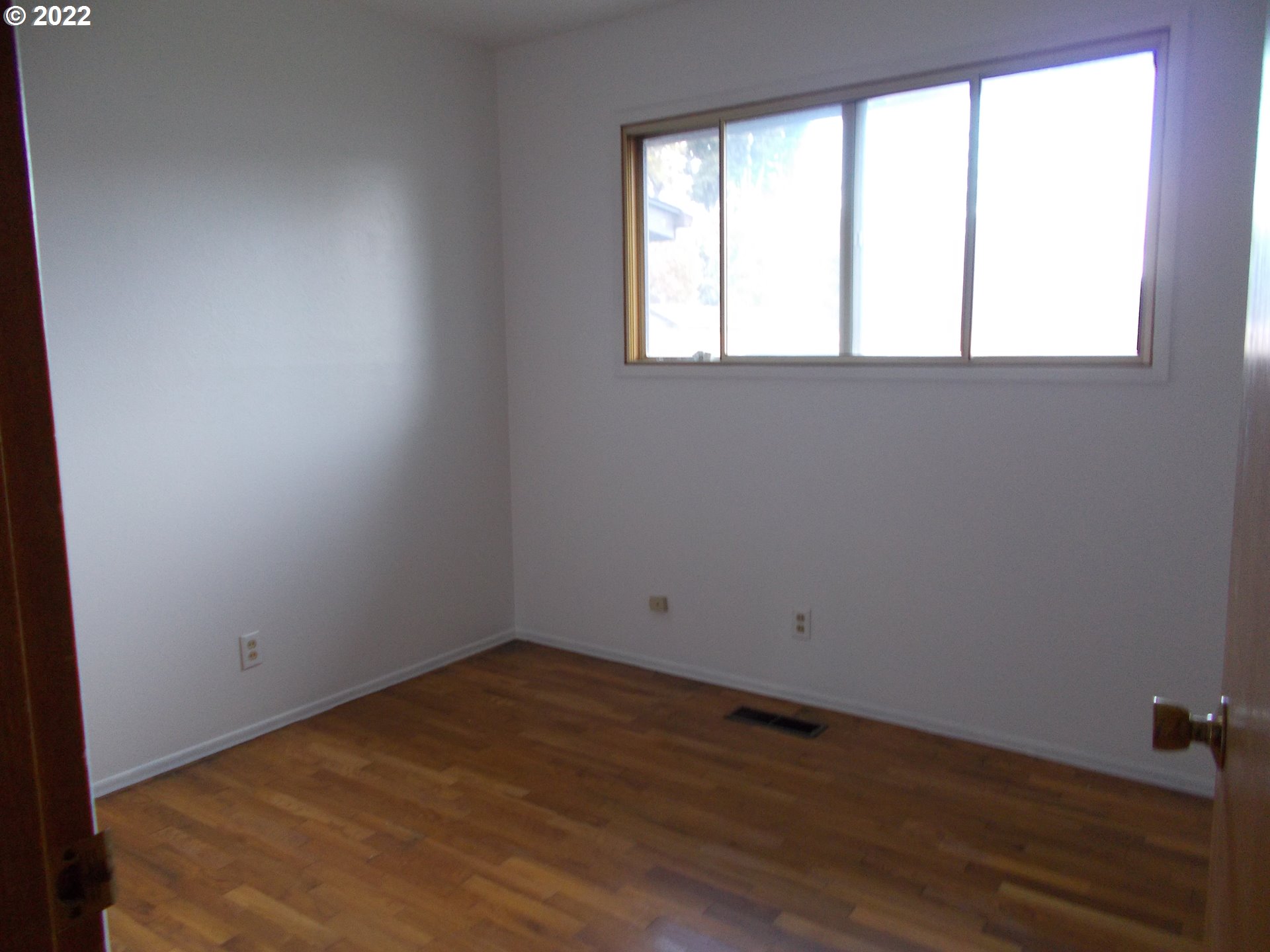 1388 Southwest 39th Street Pendleton, OR 97801 - Photo 11 of 22 an empty room with wooden floor and windows