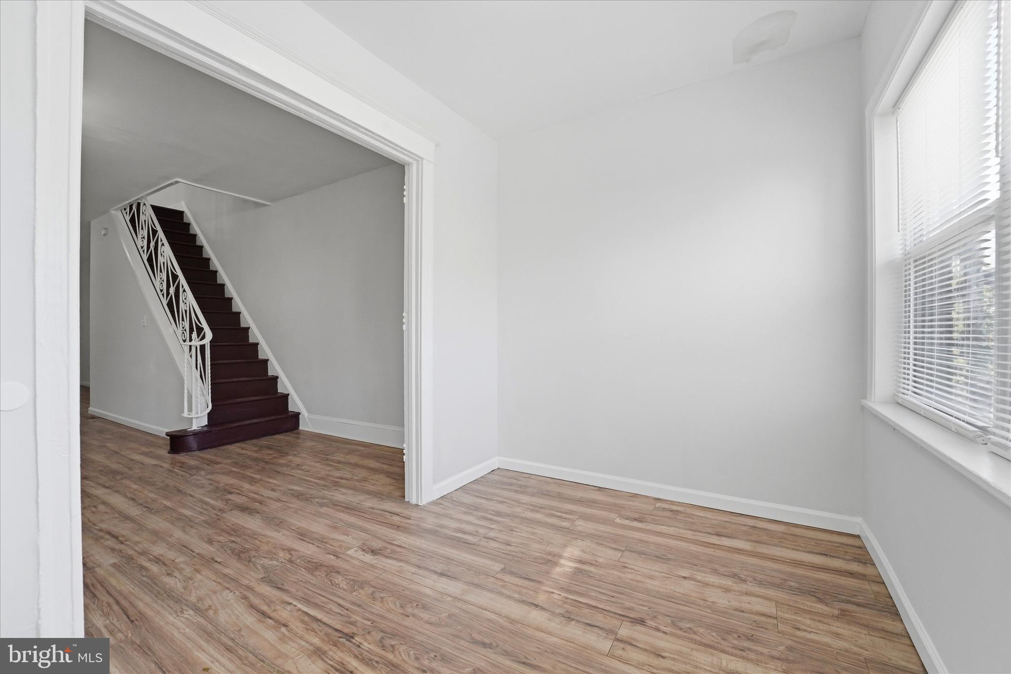 4009 Brown Street Philadelphia, PA 19104 - Photo 13 of 30 a view of an empty room with wooden floor and a window