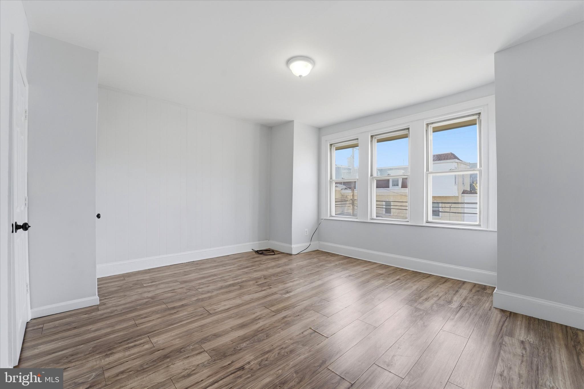 4009 Brown Street Philadelphia, PA 19104 - Photo 18 of 30 a view of an empty room with wooden floor and a window