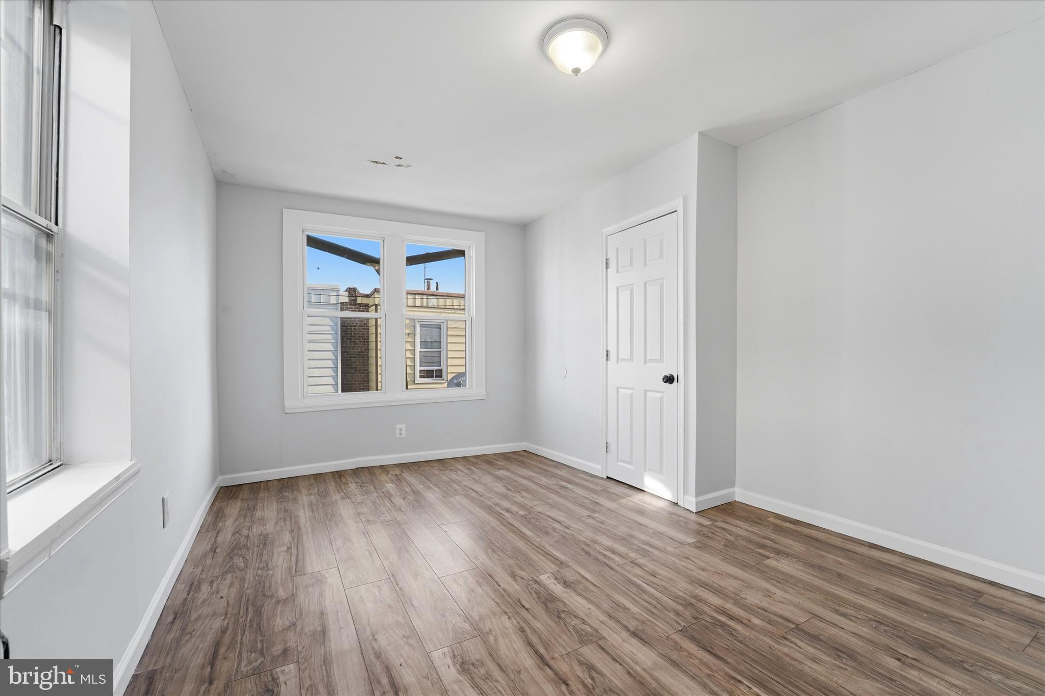 4009 Brown Street Philadelphia, PA 19104 - Photo 23 of 30 an empty room with wooden floor and windows