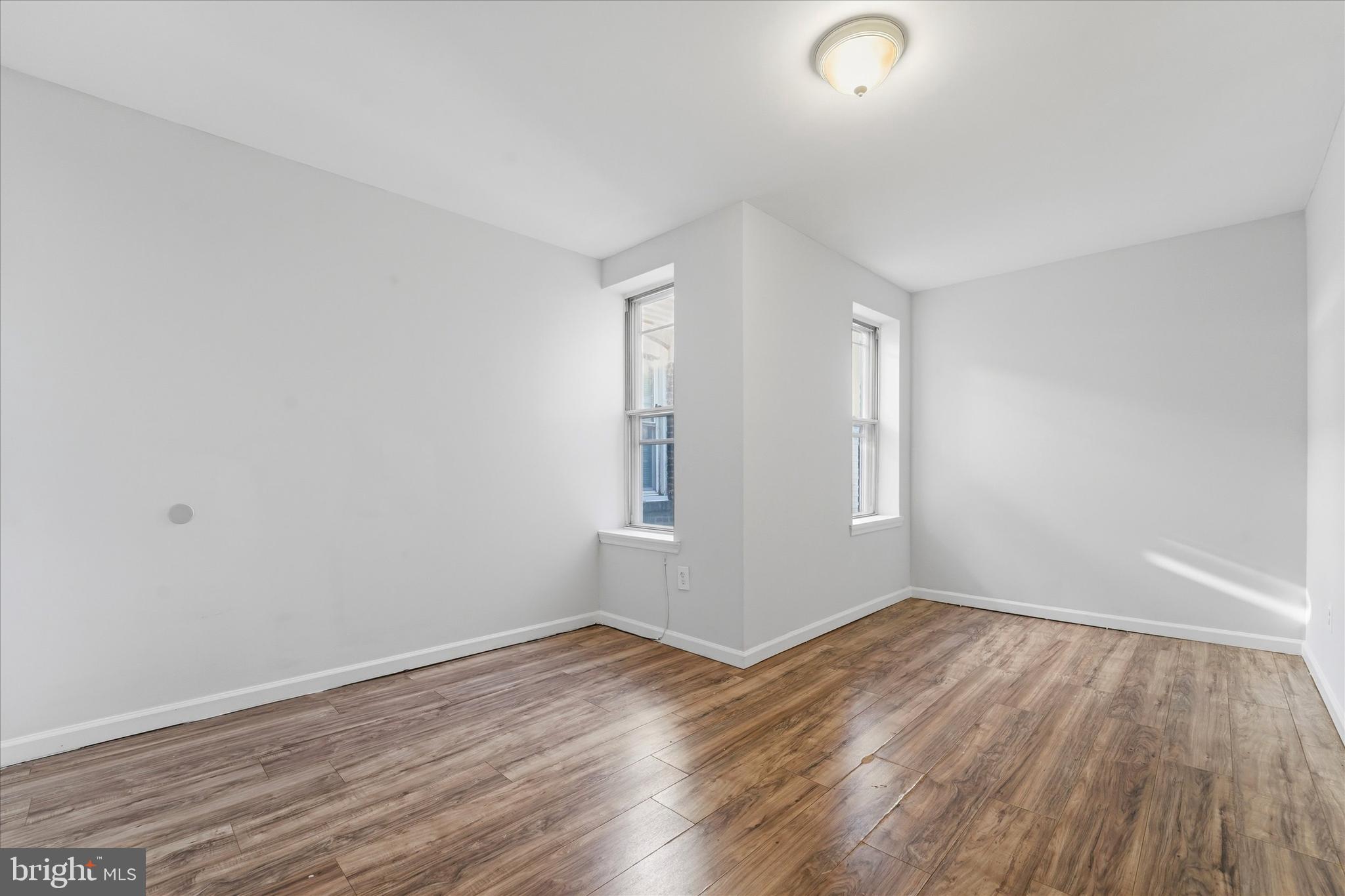4009 Brown Street Philadelphia, PA 19104 - Photo 8 of 30 a view of an empty room with wooden floor and a window