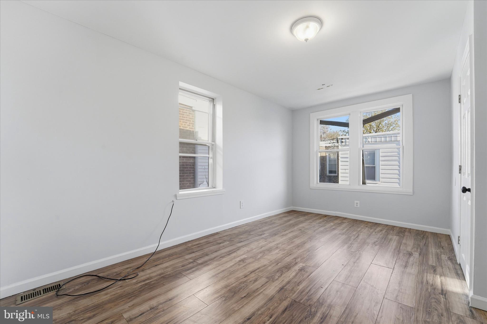 4009 Brown Street Philadelphia, PA 19104 - Photo 9 of 30 an empty room with wooden floor and windows