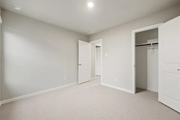 an empty room with closet area