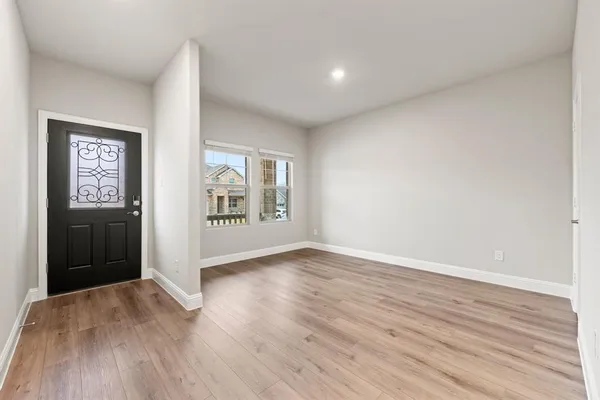 wooden floor in an empty room with a window