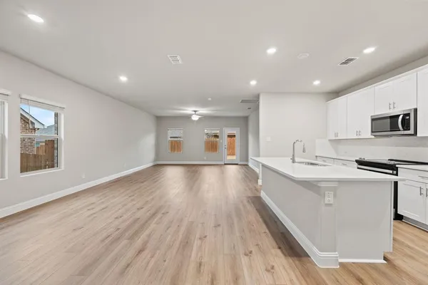 a view of kitchen with sink and wooden floor