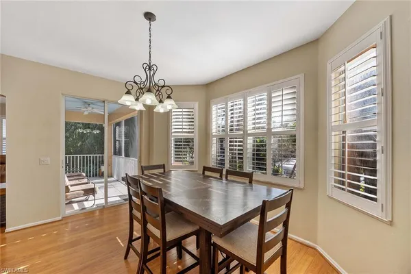 a view of a dining room with furniture wooden floor and chandelier