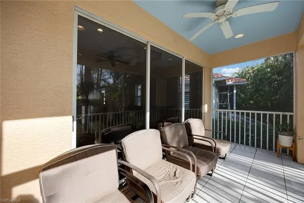 a balcony view with a couch and wooden floor