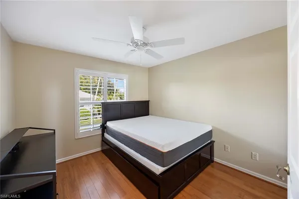 a bed sitting in a room next to a window