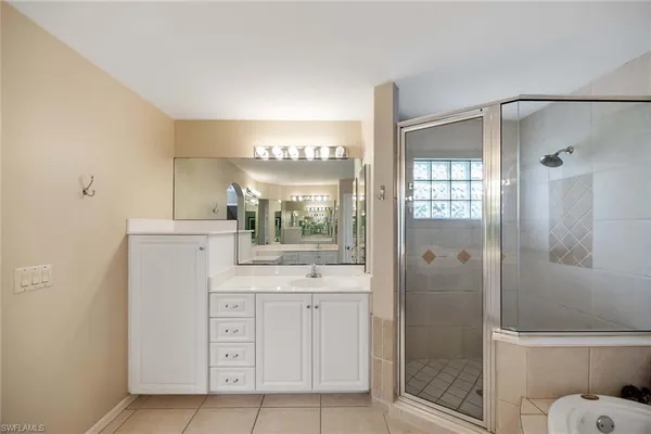 a bathroom with a shower sink and mirror