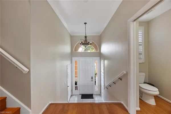a view of a hallway with a livingroom and a bathroom