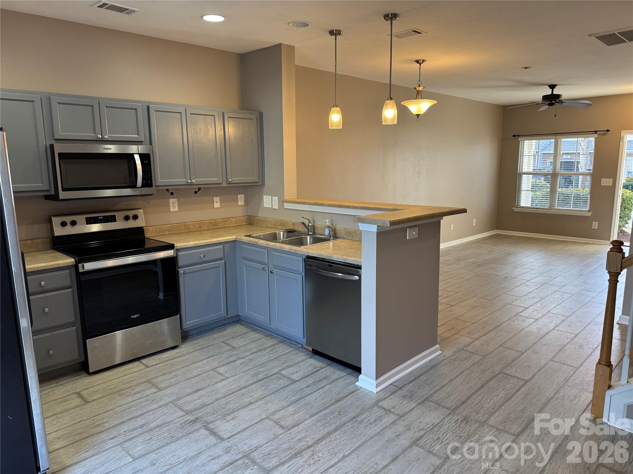 422 Delta Drive Fort Mill, SC 29715 - Photo 3 of 14 a kitchen with stainless steel appliances granite countertop a sink a stove and a wooden floors