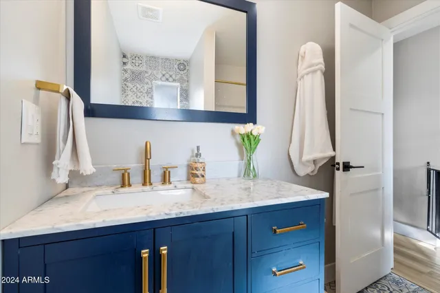 a bathroom with a sink vanity and a mirror