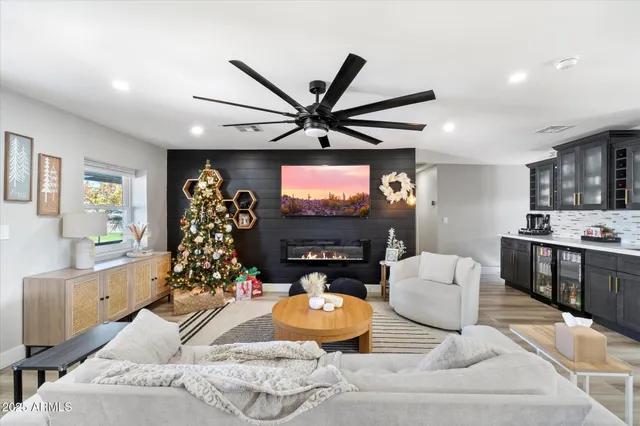 a living room with furniture a large window and a flat screen tv