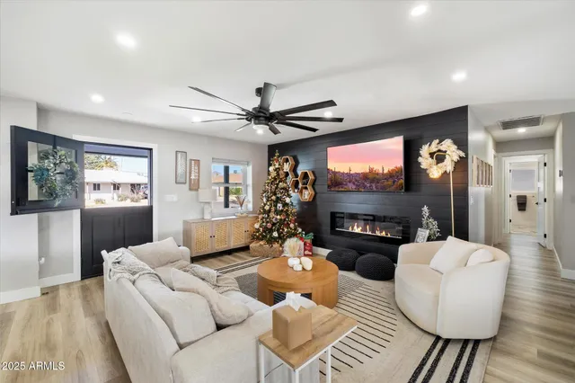 a living room with fireplace furniture and a flat screen tv