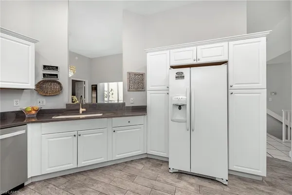 a spacious bathroom with stainless steel appliances a sink and cabinets