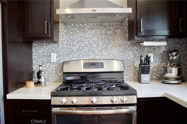 a stove top oven sitting inside of a kitchen
