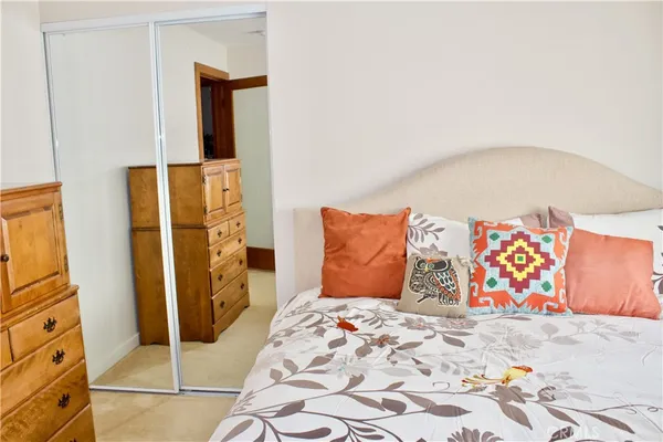 a bedroom with a bed and dresser