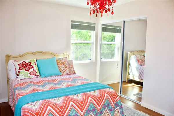 a bedroom with a bed and a chandelier