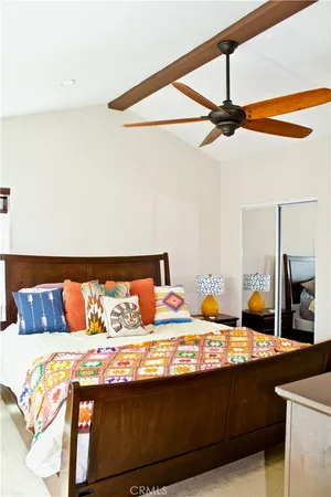 a bedroom with a bed and ceiling fan
