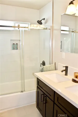 a bathroom with a sink a shower and a mirror