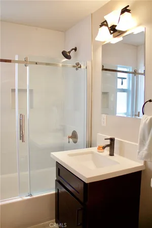 a bathroom with a sink a mirror and a bathtub