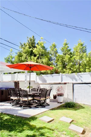 a view of a patio with chairs and plants