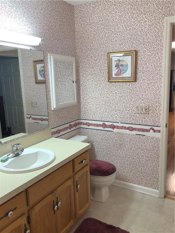 3788 Sandy Ford Road Hickory, NC 28602 - Photo 17 of 30 a bathroom with a granite countertop toilet sink and mirror