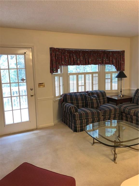 3788 Sandy Ford Road Hickory, NC 28602 - Photo 8 of 30 a living room with furniture a window and floor to ceiling window