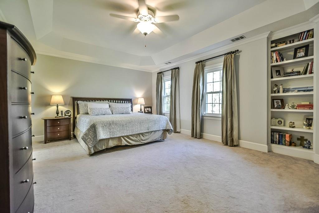 3631 Plantation Road, Unit 15 Charlotte, NC 28270 - Photo 11 of 23 a bedroom with a large bed and a chandelier