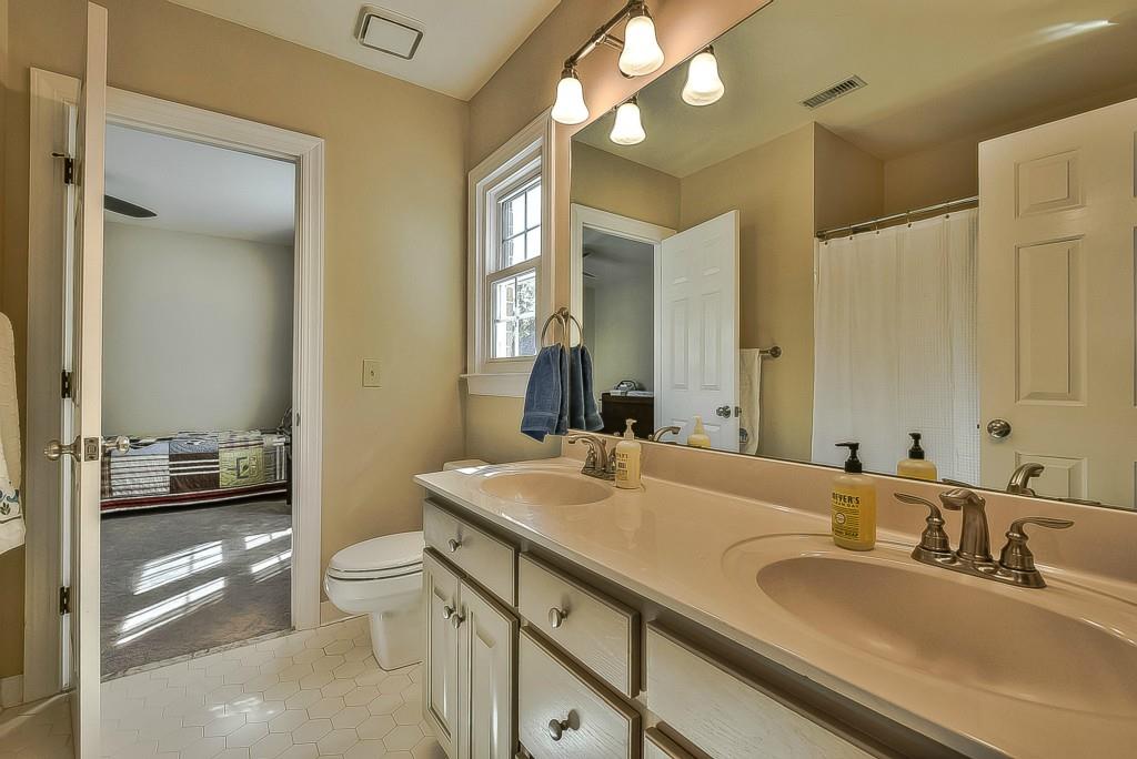 3631 Plantation Road, Unit 15 Charlotte, NC 28270 - Photo 16 of 23 a bathroom with a granite countertop double vanity sink mirror and toilet
