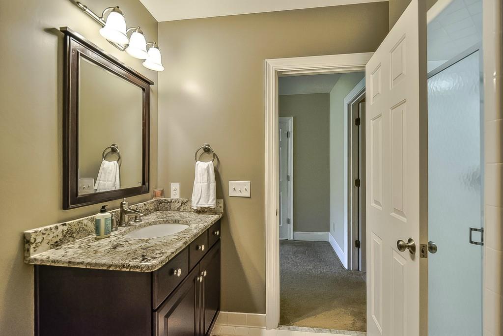 3631 Plantation Road, Unit 15 Charlotte, NC 28270 - Photo 18 of 23 a bathroom with a granite countertop sink and a mirror