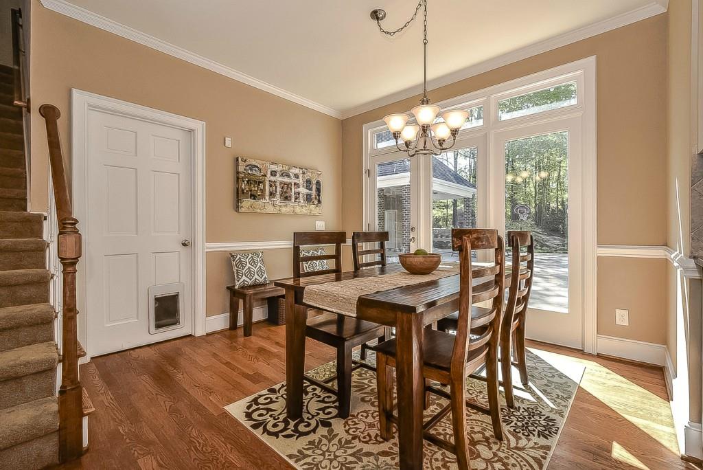 3631 Plantation Road, Unit 15 Charlotte, NC 28270 - Photo 9 of 23 a view of a dining room with furniture window and wooden floor