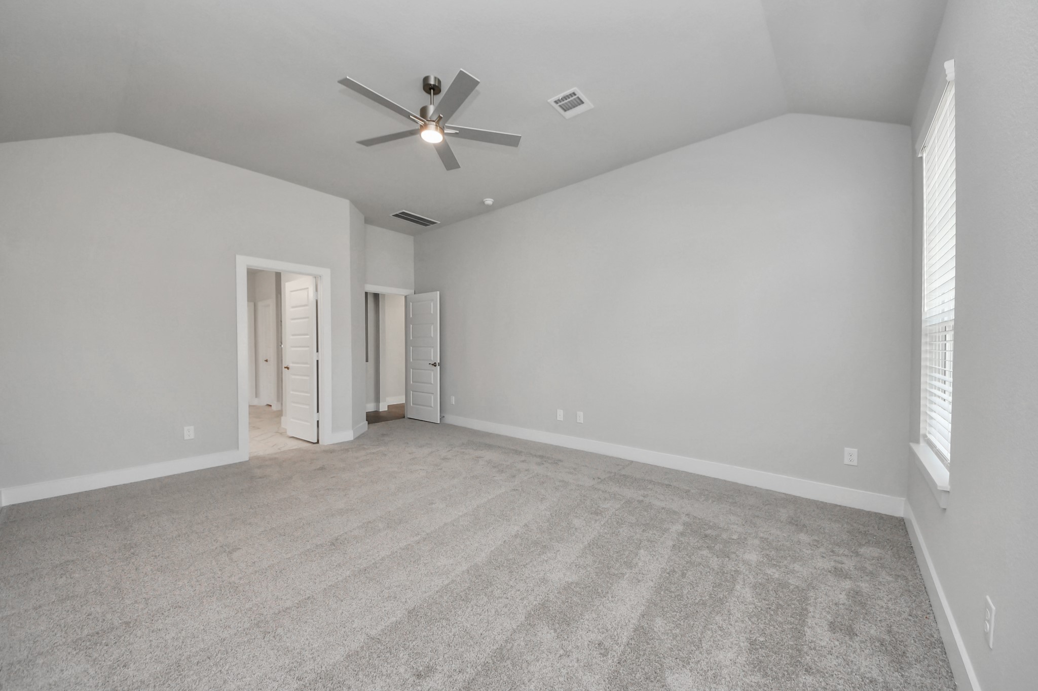 3110 Native Spg Drive Spring, TX 77373 - Photo 16 of 34 Come and unwind after a long day in this magnificent primary suite! This spacious room features plush carpet, warm paint, high ceilings and large windows with privacy blinds. Sample photo of completed home with similar floor plan. Actual colors and selections may vary.