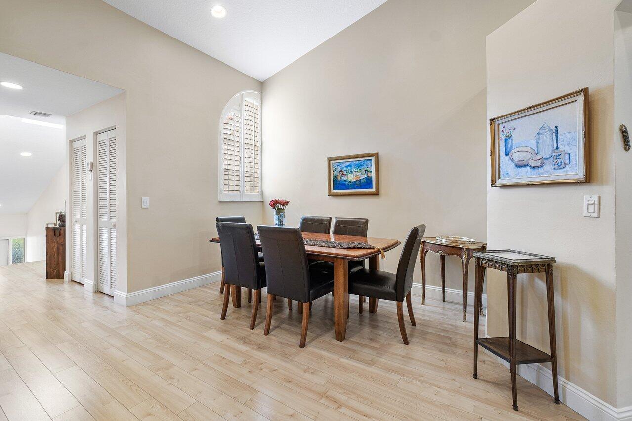 17266 Boca Club Boulevard, Unit 1603 Boca Raton, FL 33487 - Photo 11 of 42 a view of a dining room with furniture and wooden floor