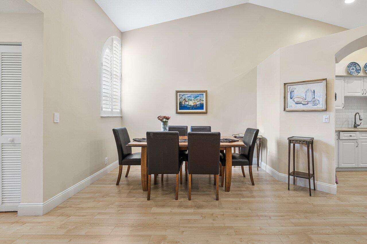 17266 Boca Club Boulevard, Unit 1603 Boca Raton, FL 33487 - Photo 12 of 42 a view of a dining room with furniture and wooden floor