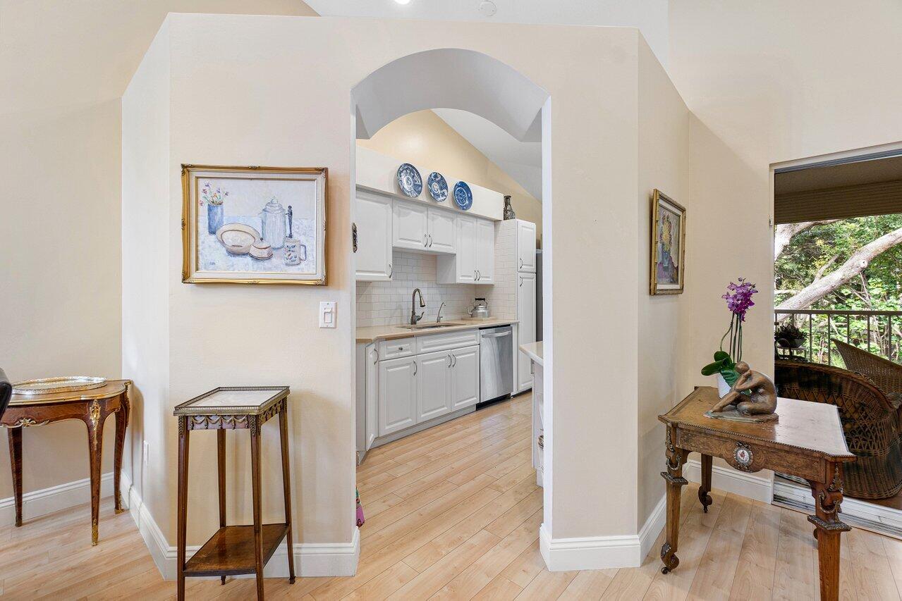 17266 Boca Club Boulevard, Unit 1603 Boca Raton, FL 33487 - Photo 13 of 42 a view of a dining room with furniture and wooden floor