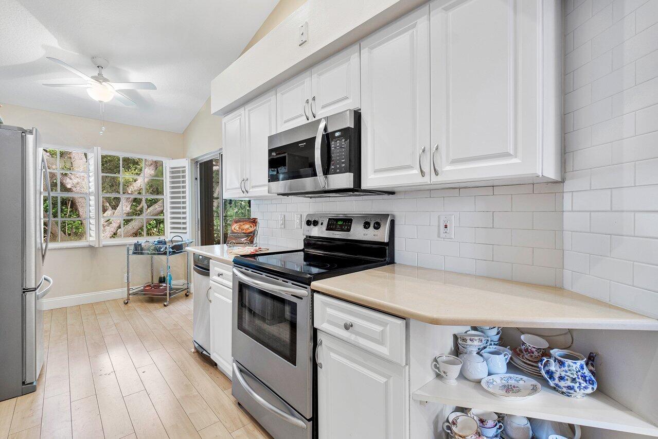 17266 Boca Club Boulevard, Unit 1603 Boca Raton, FL 33487 - Photo 16 of 42 a kitchen with stainless steel appliances granite countertop a stove and a refrigerator