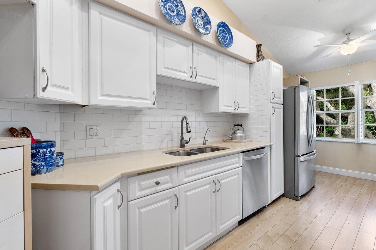 17266 Boca Club Boulevard, Unit 1603 Boca Raton, FL 33487 - Photo 17 of 42 a kitchen with a sink cabinets and window
