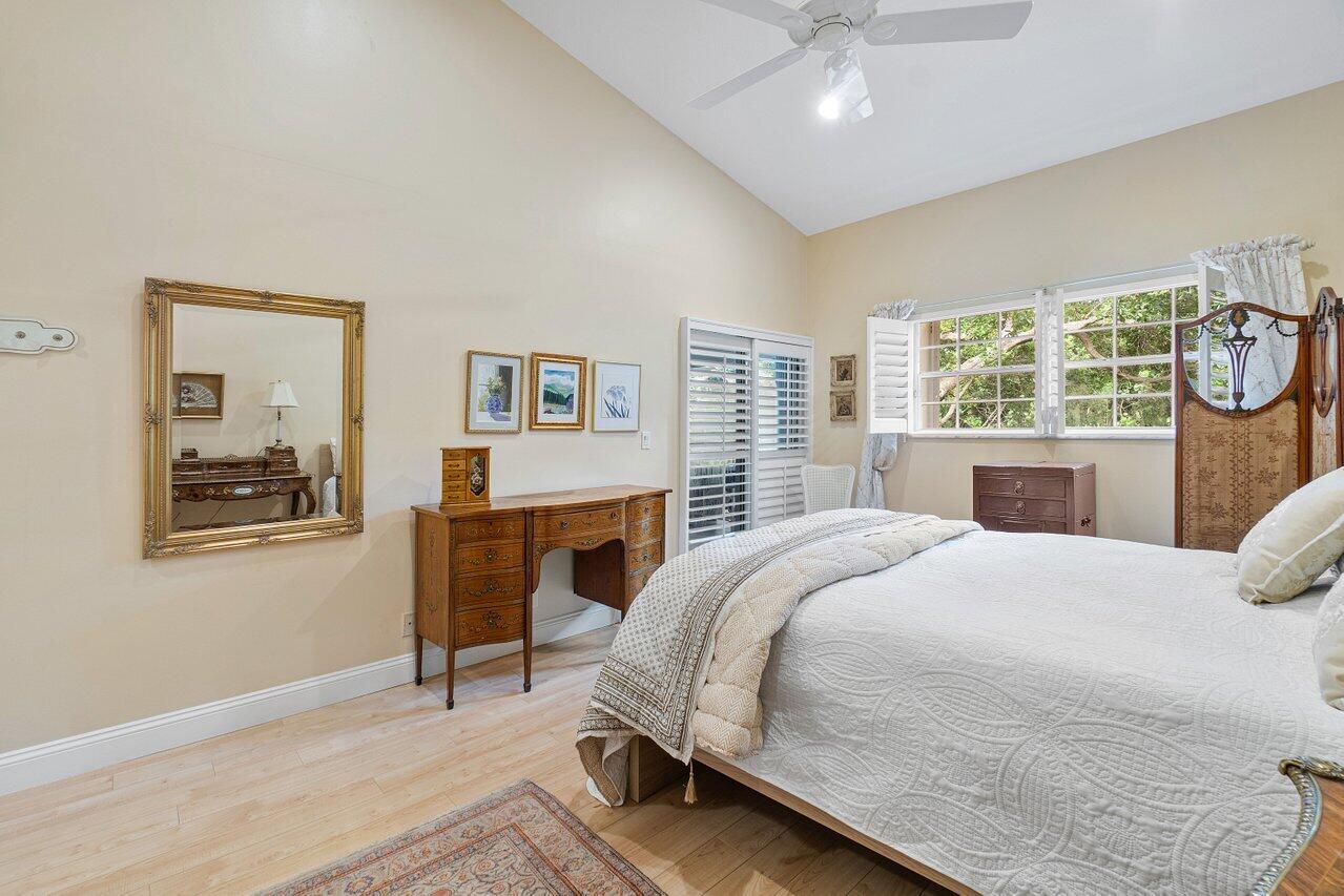 17266 Boca Club Boulevard, Unit 1603 Boca Raton, FL 33487 - Photo 20 of 42 a bedroom with a bed a chandelier and mirror