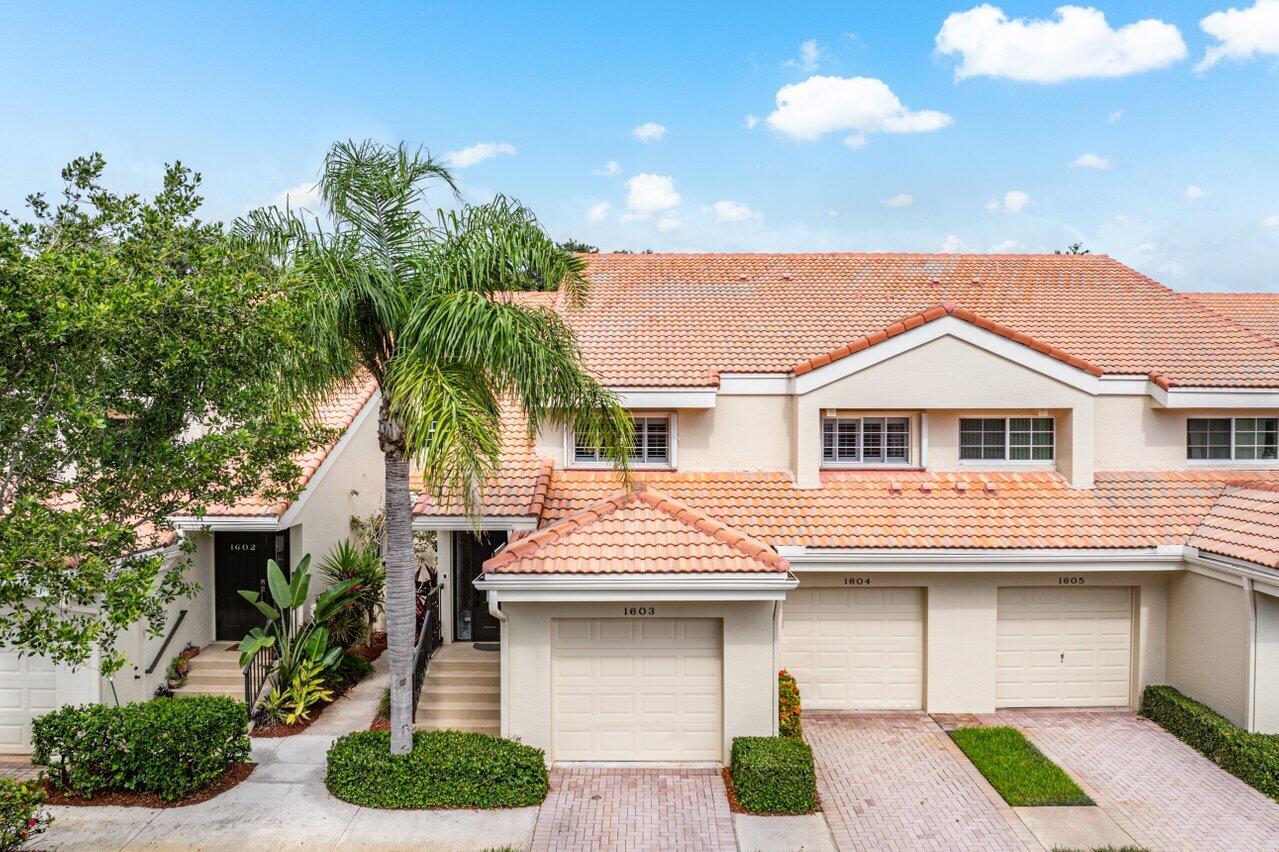 17266 Boca Club Boulevard, Unit 1603 Boca Raton, FL 33487 - Photo 2 of 42 a front view of a house with garden