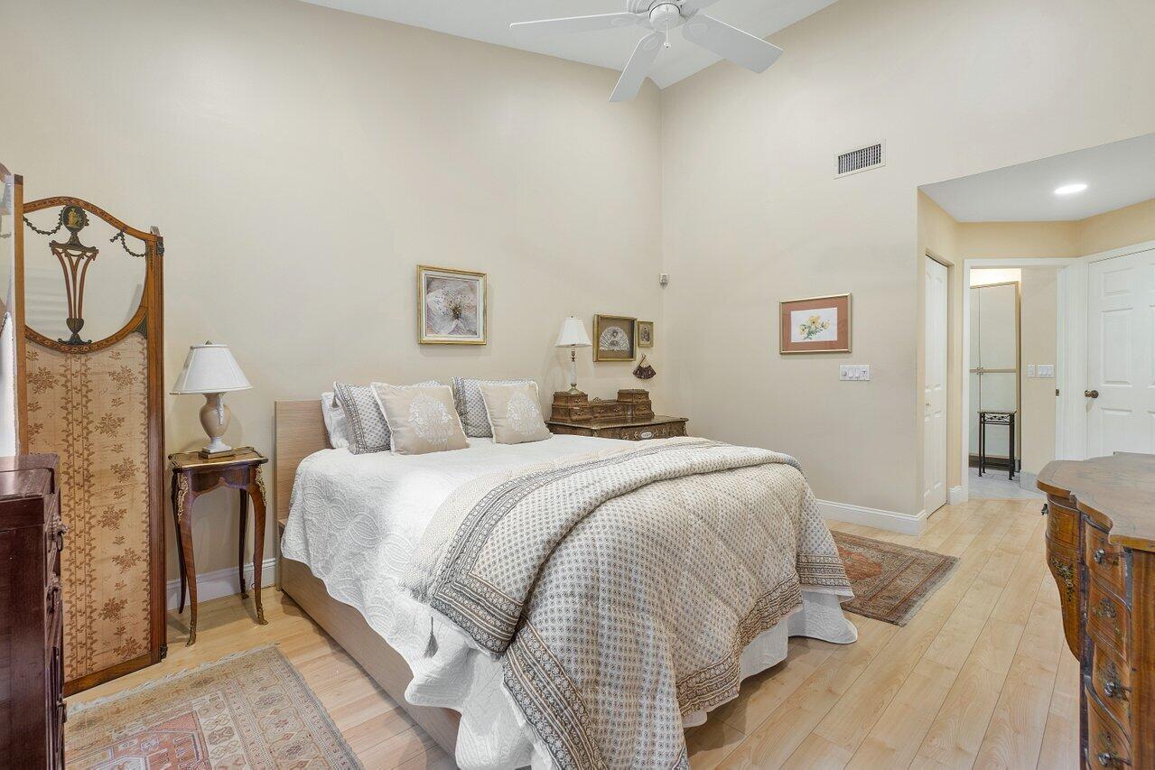 17266 Boca Club Boulevard, Unit 1603 Boca Raton, FL 33487 - Photo 21 of 42 a bed room with a bed and a chandelier