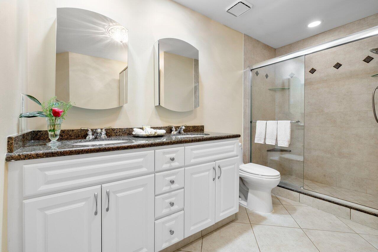 17266 Boca Club Boulevard, Unit 1603 Boca Raton, FL 33487 - Photo 23 of 42 a bathroom with a double vanity sink mirror and toilet