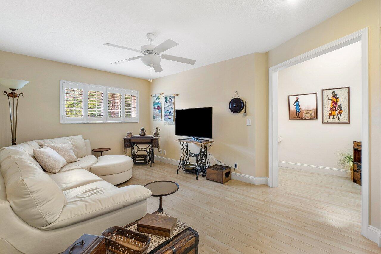 17266 Boca Club Boulevard, Unit 1603 Boca Raton, FL 33487 - Photo 25 of 42 a living room with furniture a flat screen tv and a window