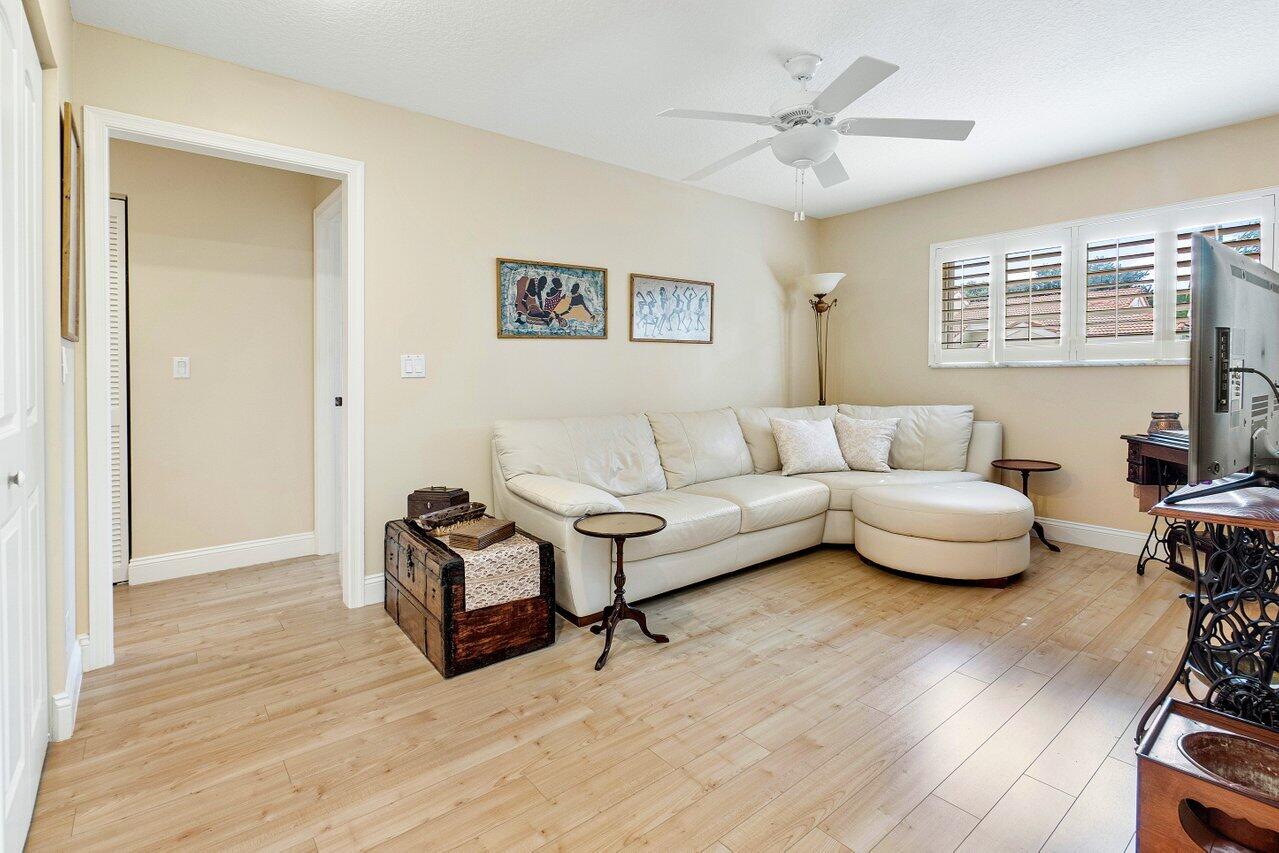17266 Boca Club Boulevard, Unit 1603 Boca Raton, FL 33487 - Photo 27 of 42 a living room with furniture and a wooden floor