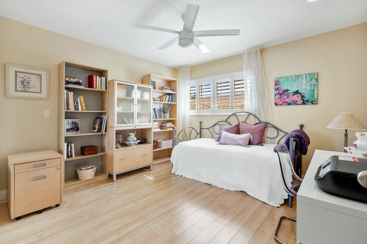 17266 Boca Club Boulevard, Unit 1603 Boca Raton, FL 33487 - Photo 28 of 42 a bed room with a bed and a book shelf