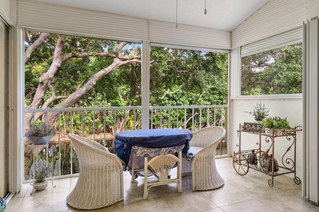 17266 Boca Club Boulevard, Unit 1603 Boca Raton, FL 33487 - Photo 33 of 42 a view of a porch with furniture and a yard